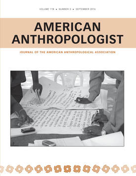 Cover of the journal American Anthropologist with a cover image of the hands of development workers collaborating on a paper presentation.